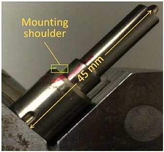 Photograph of fuel injector, with mounting shoulder region outlined in yellow