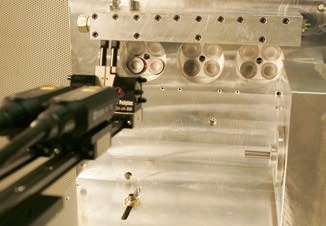 A look at the valves of the test sample, mounted to the cylinder head mock-up. The laser vibrometer is in the foreground.