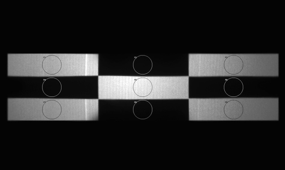 A checkerboard test pattern projected by a HUD system is analyzed by light measurement software to calculate the contrast ratio by dividing the average white values with average black values. A human inspector, however, may not need to perform a calculation to make a quality determination.