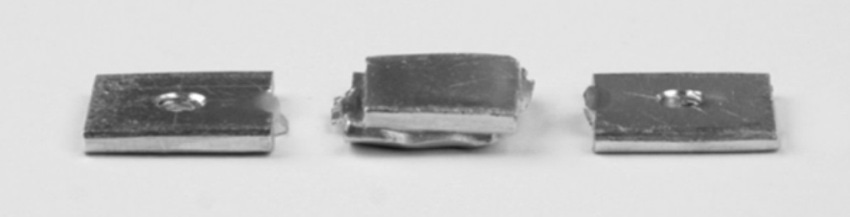 Welded specimens (center) with the clamped parts.