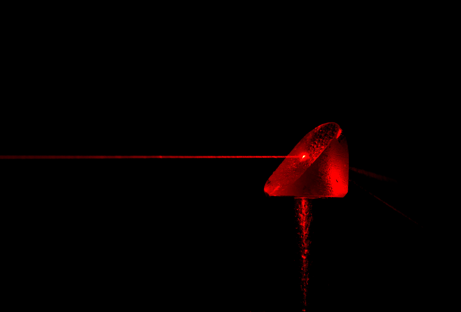 A red laser shown through water