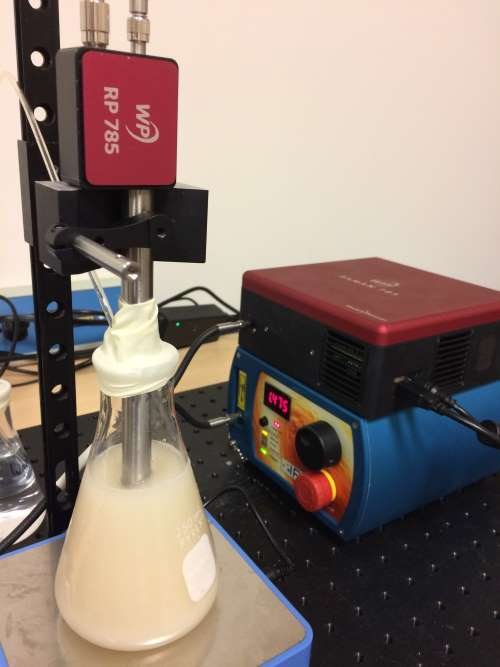 Fermentation Setup (front) on magnetic stirrer (bottom) with probe (top) and spectrometer and laser (back).