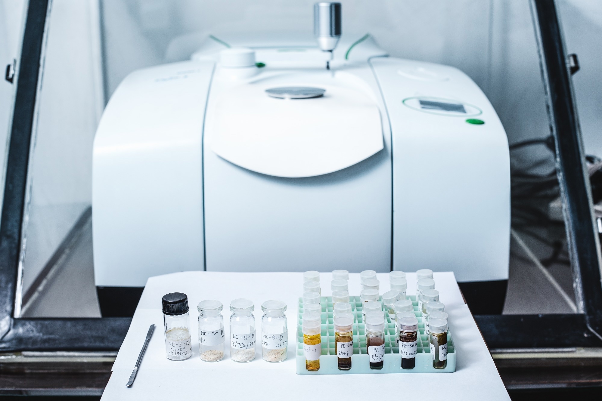 Fourier Transform Infrared Spectroscopy FTIR instrument and sample in vials for analysis.