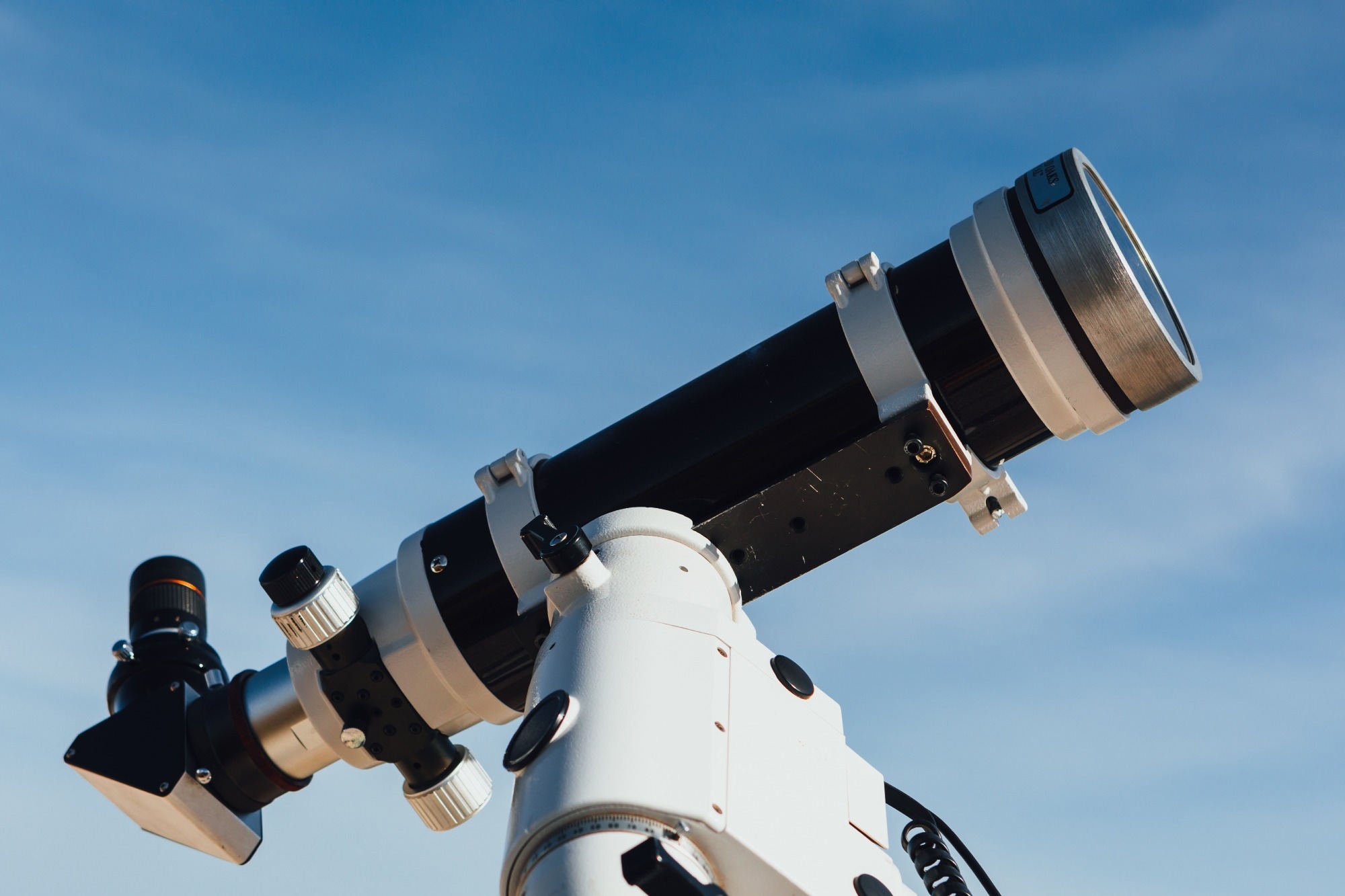astronomical telescope tube, blue sky background