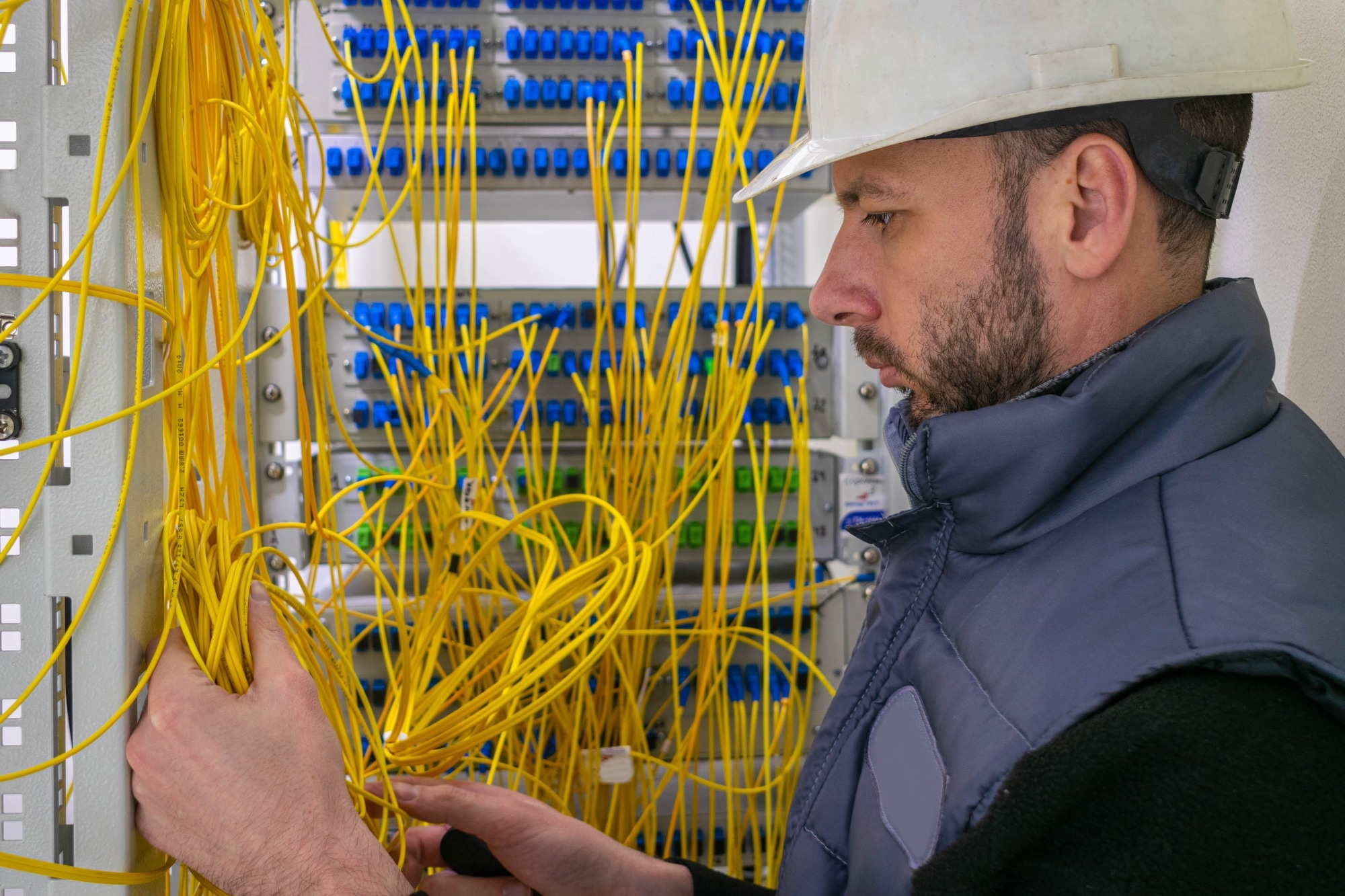 Electrical engineer installing fiber optics.