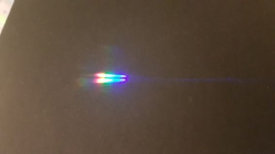 Visible and near UV light, dispersed by a prism, positioned just before the focal plane of the focusing plano convex lens