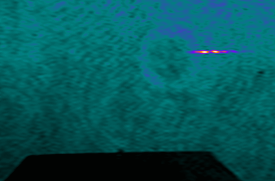 A snapshot of laser-plasma interaction with the gas nozzle (black region). The “bright line” is coming from the self-emission of the plasma where the PHELIX laser intensity is the highest