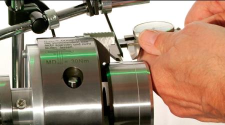 (a) Typical string method assembly with test shaft mounted. (b) Shaft is rotated both clockwise and counterclockwise to inspect string traverse. (c) Distance of string traveled is measured with verneers.
