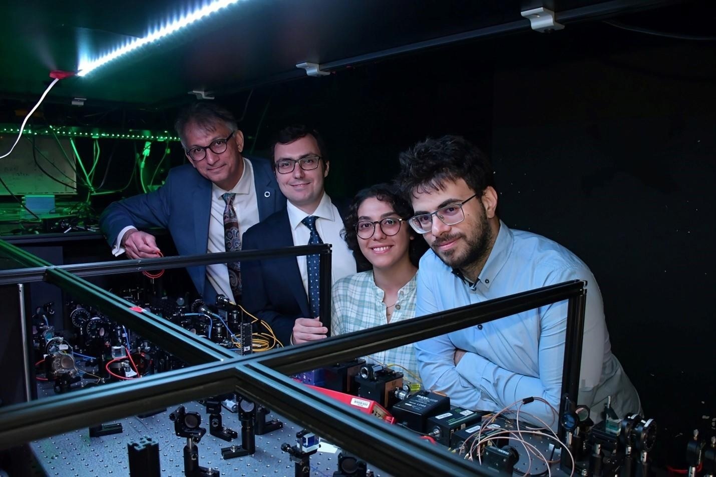 The research team in their laboratory. From left to right: Professor Karimi, Francesco Di Colandrea, Nazanin Dehghan, and Allesio D’Errico. Image Credit: University of Ottawa
