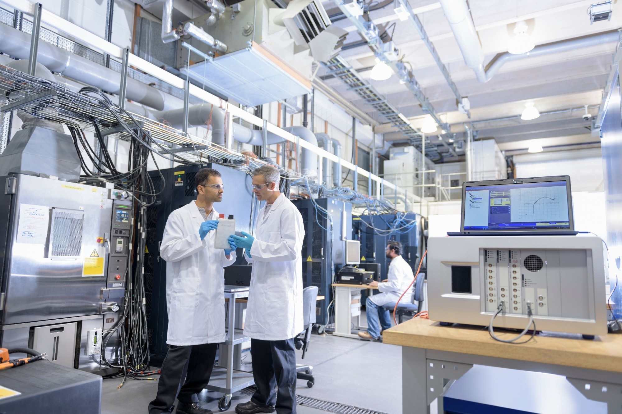 Scientists in lithium ion battery testing facility in battery research facility