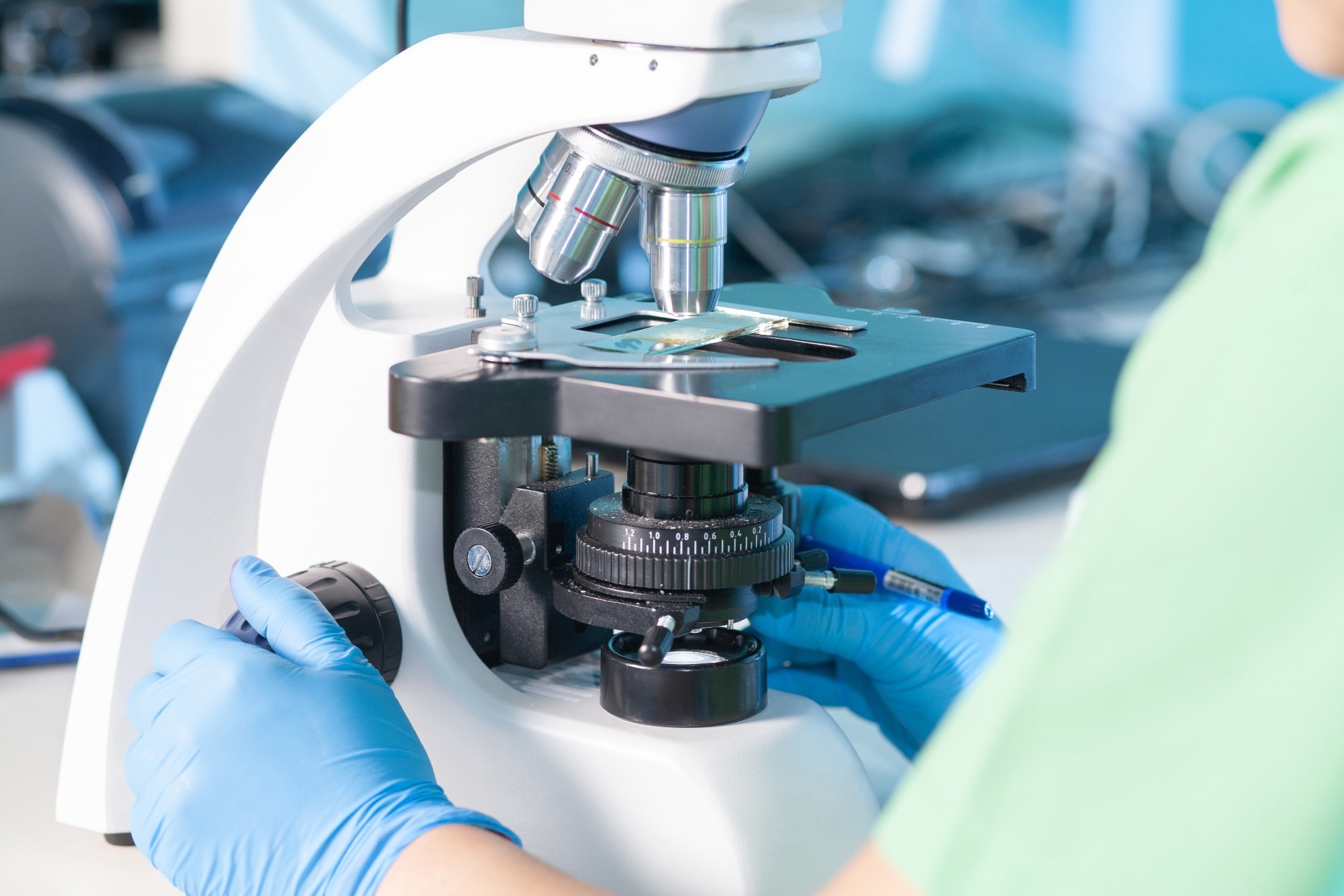 scientist working with a light microscope in a research laboratory