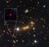Hubble Space Telescope and A Cosmic Zoom Lens Uncover Farthest Known Galaxy